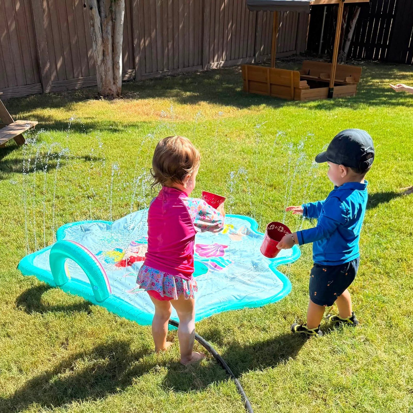 Backyard splash pad on a sunny day